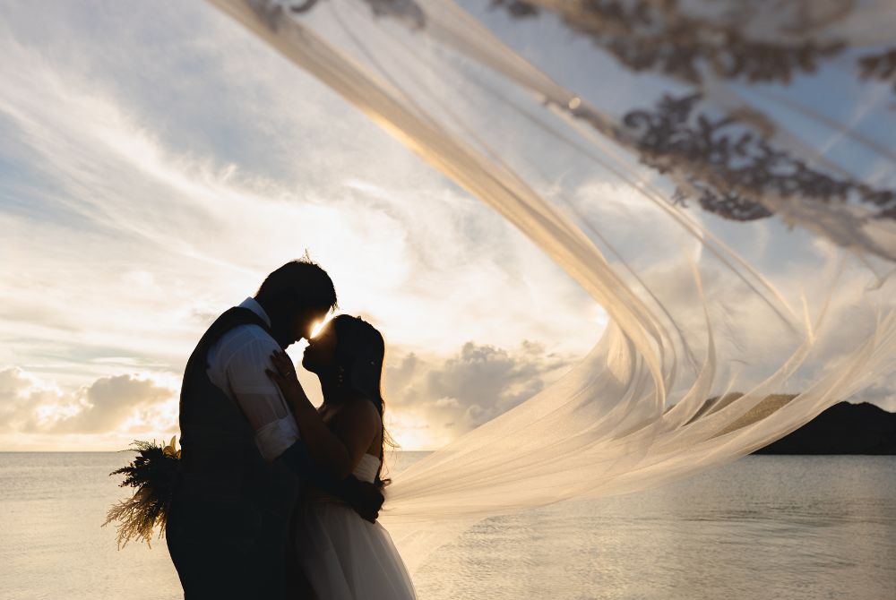 sunset shooting at the beach with veil