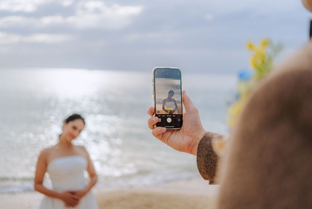 taking photo of bride