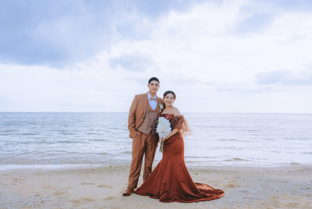 a couple with red dress and brownish tuxedo