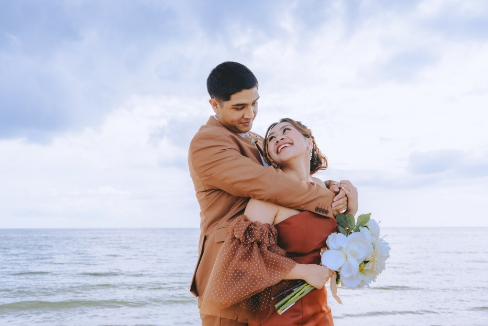 groom holding bride from the back