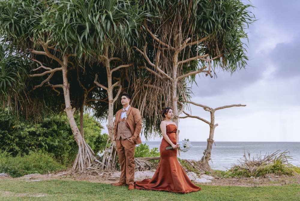 posing in front of tropical green
